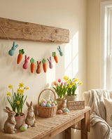 Easter decorations including bunnies, carrots, and Easter eggs on a wooden table with a 'Happy Easter' sign.