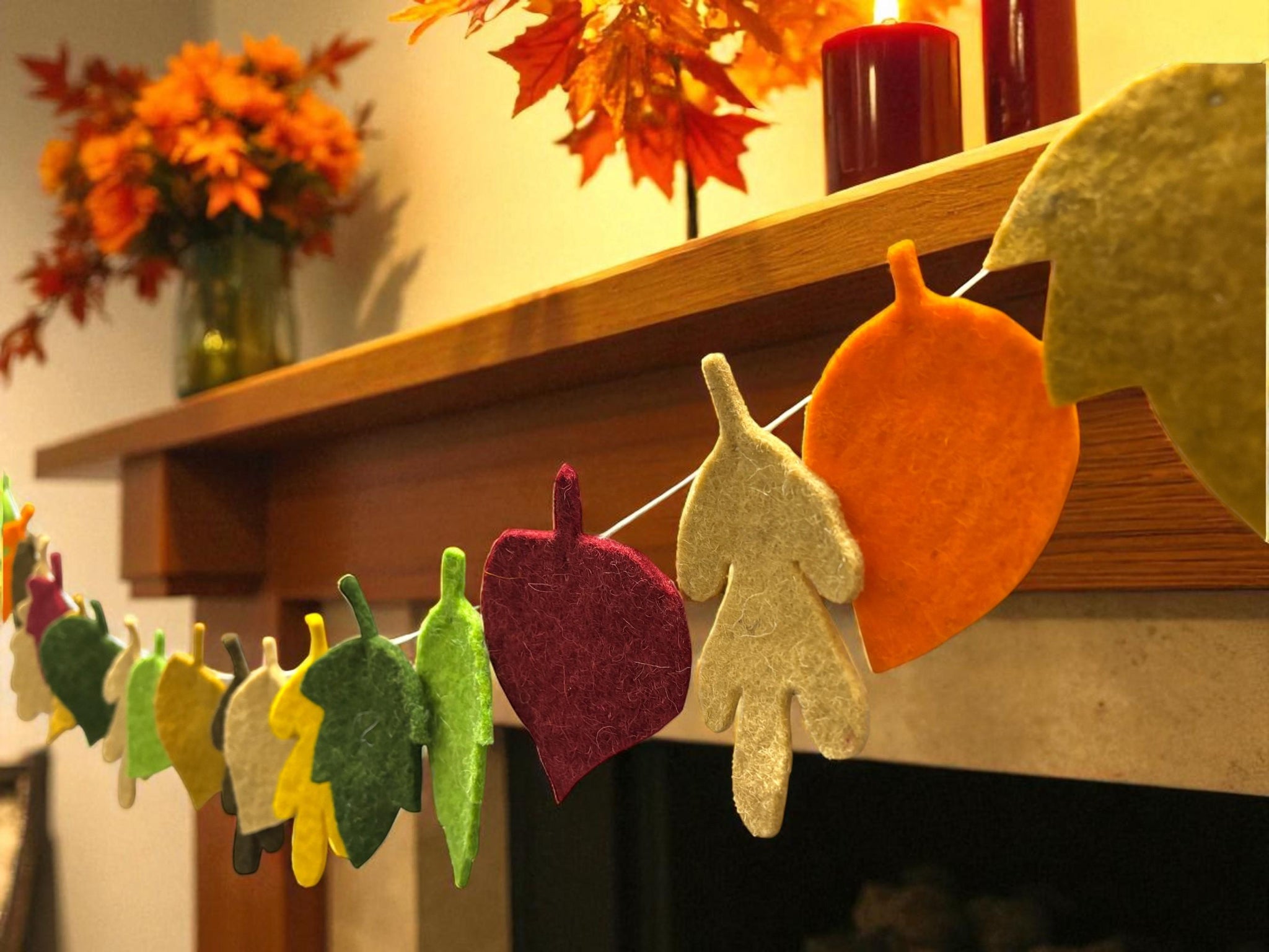 Decorative leaf garland with a fireplace and autumn leaves in the background