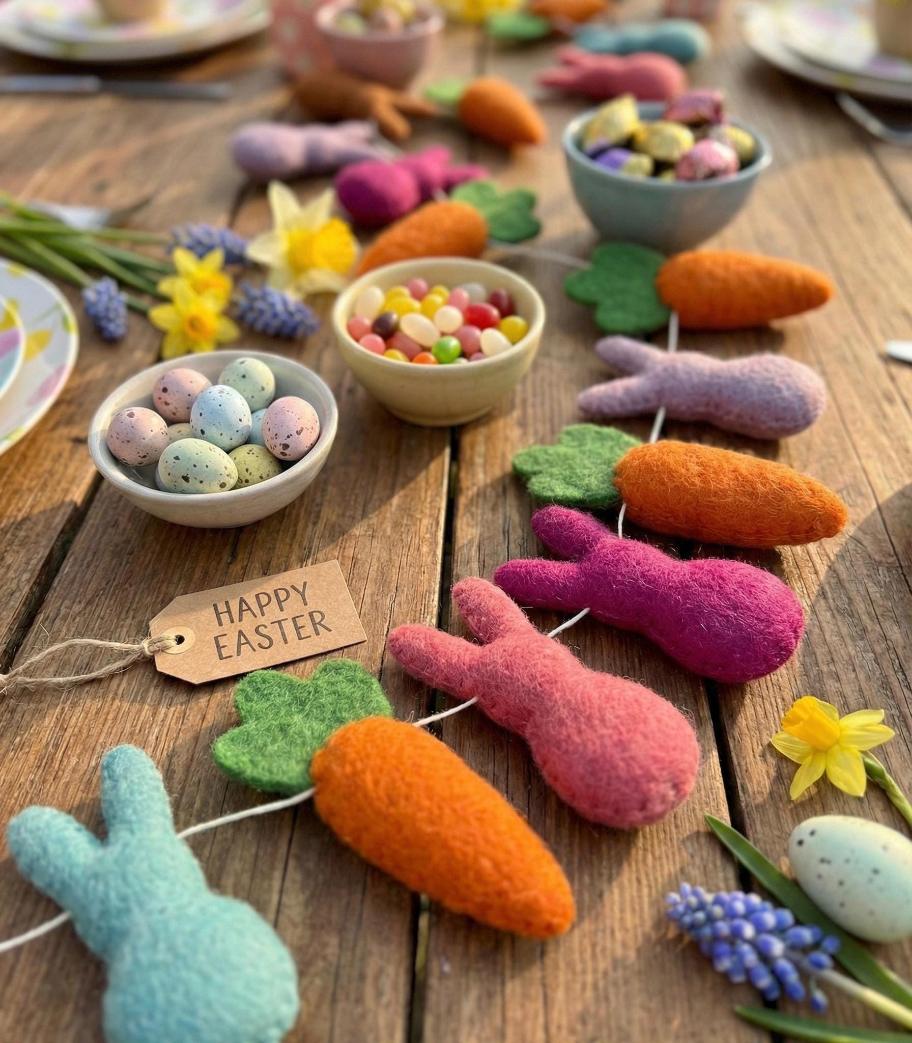 Easter-themed decorations including felt bunnies, carrots, and eggs on a wooden table.