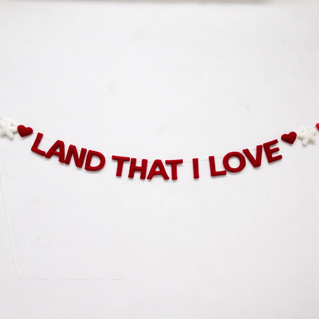 Decorative banner with 'LAND THAT I LOVE' text on a white background