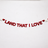 Decorative banner with 'LAND THAT I LOVE' text on a white background