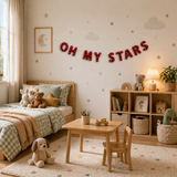 Children's bedroom with bed, table, chairs, and decorative elements.
