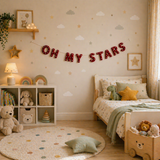 Children's bedroom with 'Oh My Stars' banner, teddy bear, and toys.