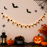 Halloween-themed decorations including a 'Trick or Treat' banner, pumpkins, and spiders on a wall.
