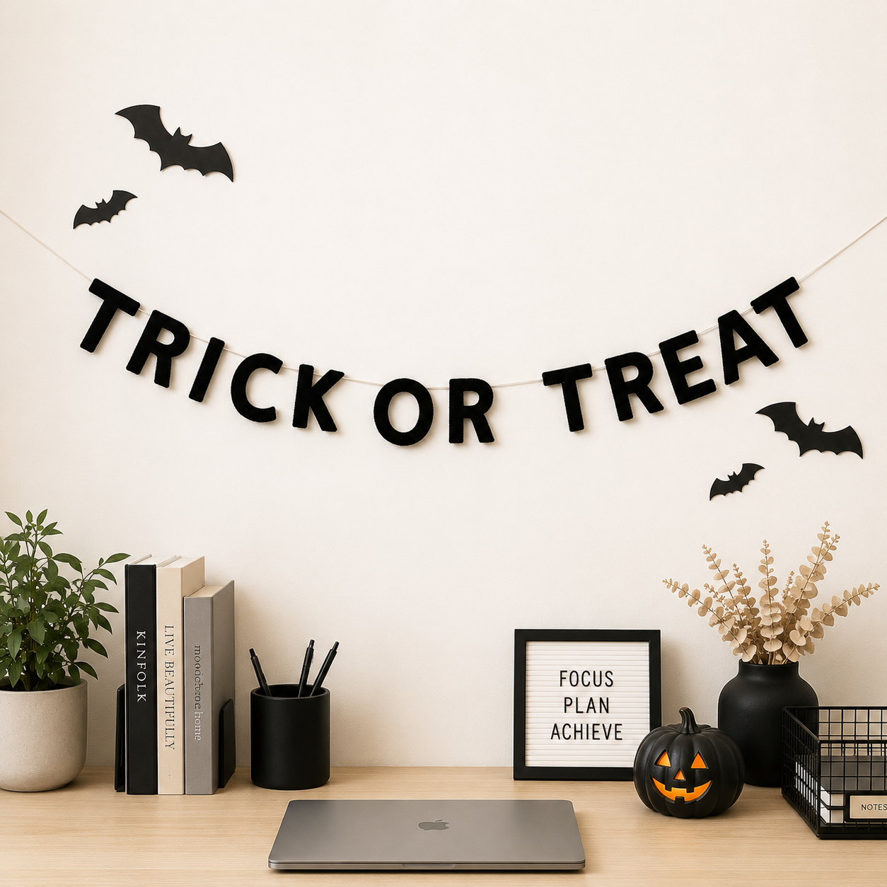 Halloween-themed desk setup with 'Trick or Treat' banner, pumpkins, and decorative items.