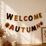 Decorative banner with 'Welcome Autumn' text on a wall with a warm ambiance.