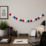 Home office desk setup with motivational decor, books, and a calendar.