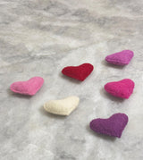 Colorful heart-shaped objects on a marble surface