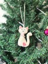 Cat-shaped Christmas ornament hanging on a tree